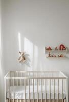 Minimalist nursery with clean white walls, a simple crib, and a small shelf with toys neatly arranged photo