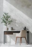 Minimalist workspace with a sleek desk, chair, and a simple plant adding a touch of greenery photo