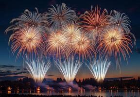 A spectacular finale of fireworks, with layers of colors and light filling the sky over a lake photo