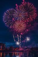 Bright fireworks exploding in the night sky over a cityscape, reflecting off nearby buildings and water photo