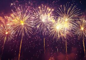 Fireworks bursting in the sky above a festive celebration, with shimmering sparks falling gracefully photo