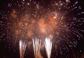 Fireworks bursting in the sky above a festive celebration, with shimmering sparks falling gracefully photo