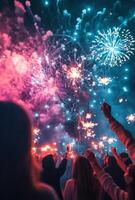 Fireworks illuminating a festive scene, with people holding sparklers in the foreground, celebrating the New Year photo