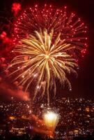 Golden and red fireworks spreading across the sky, with city lights twinkling in the background photo