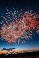 A panoramic view of fireworks with sparkling colors, creating a festive atmosphere against a starry night photo