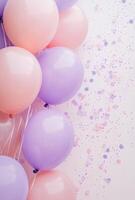 Soft pink and lavender balloons on the left side, paired with delicate confetti, leaving free space on the right for design elements photo