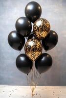Elegant black and gold balloons with matching confetti, creating a sophisticated party vibe with open space in the center photo