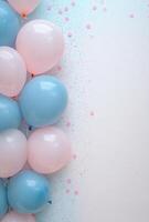 Soft baby blue and blush pink balloons on the left, with pastel confetti, leaving a clean and open space on the right for design or text photo