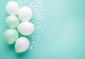 Pastel mint and white balloons on the left side, accompanied by light confetti, with plenty of free space on the right for text or design photo