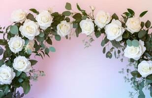 A white rose arch with green leaves on it photo