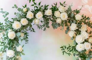 A wedding arch made of white roses and eucalyptus photo