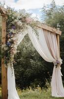 Wedding arch with drapes and flowers photo