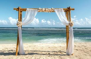 An arch on the beach with white drapes photo