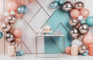 Balloons and cake on a table with a backdrop photo