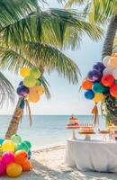 A beachside birthday setup with tropical decorations, colorful balloons tied to palm trees, and a cake table overlooking the ocean photo