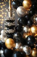 A luxurious birthday setting with black, gold, and silver balloons, a champagne tower, and sparkling lights for an elegant celebration photo