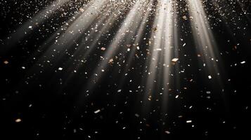 Abstract image of falling confetti illuminated by soft, scattered light rays, creating a magical and ethereal atmosphere over a black background photo