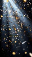 A burst of sparkling confetti, with golden and silver pieces glinting under bright, focused beams of light, set against a dark, mysterious background photo