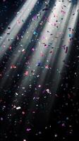 Soft, multicolored confetti drifting through shafts of light, with the dark background creating a stark, captivating contrast photo