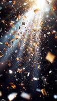 A burst of sparkling confetti, with golden and silver pieces glinting under bright, focused beams of light, set against a dark, mysterious background photo