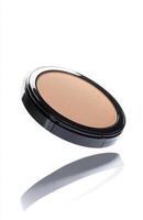 A flat cosmetic compact case levitating in mid-air, with clean edges and smooth reflections, isolated on a bright white background photo