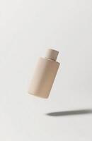 A minimalist cosmetic bottle floating in mid-air, isolated on a clean white background, casting a soft shadow below, perfect for mockup photo