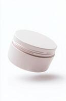 A plain, round cosmetic jar floating at an angle in mid-air, with smooth lighting and subtle reflections on its surface, isolated on white photo