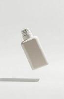 A minimalist cosmetic bottle floating in mid-air, isolated on a clean white background, casting a soft shadow below, perfect for mockup photo
