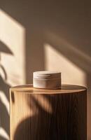 A plain, elegant cosmetic jar on a smooth wooden podium, with natural lighting creating gentle shadows on the product and surface photo