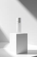 A white container with a white lid sitting on a white cube photo