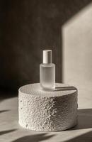 A bottle of perfume sitting on top of a white table photo