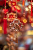 A chinese ornament hanging from a string photo