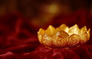 Golden lotus flower candle on red cloth photo