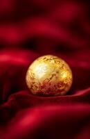 Golden egg on red velvet background photo