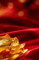 Golden lotus flower on red silk background photo
