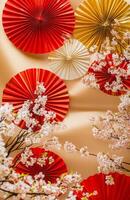Red and gold paper fans and cherry blossom branches photo