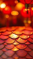 A close-up of snake scales glowing under soft red and gold lantern lights, with subtle Chinese New Year decorations in the background photo
