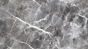 A close-up top view of polished grey marble with soft white veining, filling the frame with a sleek and contemporary texture photo