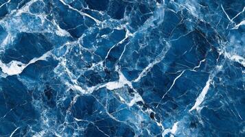 A close-up top view of blue marble with contrasting white and grey veins, adding a cool, serene feel to the design photo