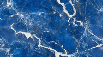 A close-up top view of blue marble with contrasting white and grey veins, adding a cool, serene feel to the design photo