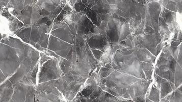 A close-up top view of polished grey marble with soft white veining, filling the frame with a sleek and contemporary texture photo