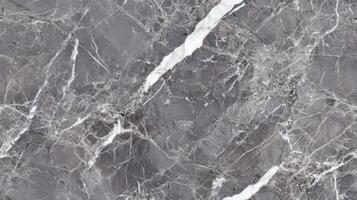 A close-up top view of polished grey marble with soft white veining, filling the frame with a sleek and contemporary texture photo