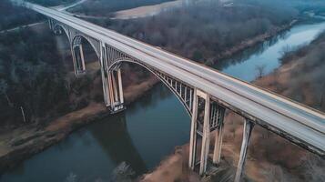An expansive highway bridge crossing over a river, surrounded by nature and no signs of human activity photo