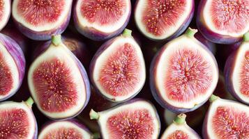 Rows of perfectly aligned halved figs, the deep purple skins and pink centers forming a rich, detailed pattern photo