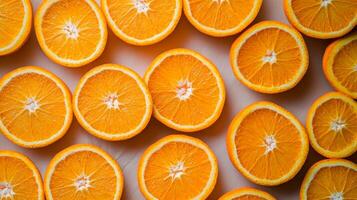 Top view of perfectly aligned rows of bright orange slices, filling the frame with a vibrant citrus pattern photo