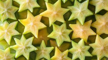 Top view of rows of starfruit slices, their unique star shapes forming a repeating tropical pattern photo