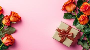 Valentine's Day flat lay with roses and a beautifully wrapped gift box in one corner of the pink background photo