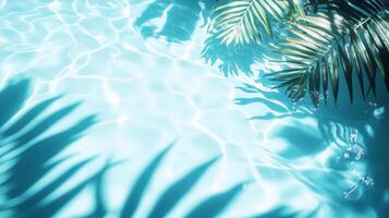 A tropical setting with aqua waves and lush leaf shadows softly playing on a bright blue pool texture photo