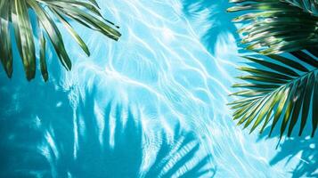 A tropical setting with aqua waves and lush leaf shadows softly playing on a bright blue pool texture photo