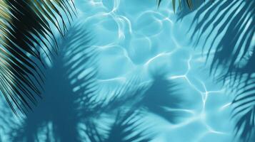 Bright blue pool water with soft ripples, highlighted by tropical leaves' shadows gently swaying on the surface photo